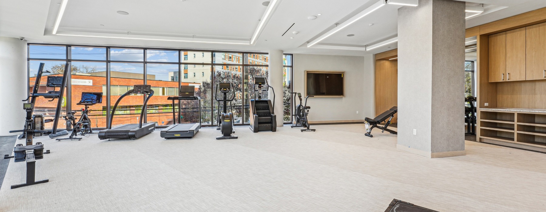 fitness center with open windows and full equipment package