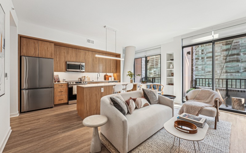 living room with couch, kitchen and private balcony